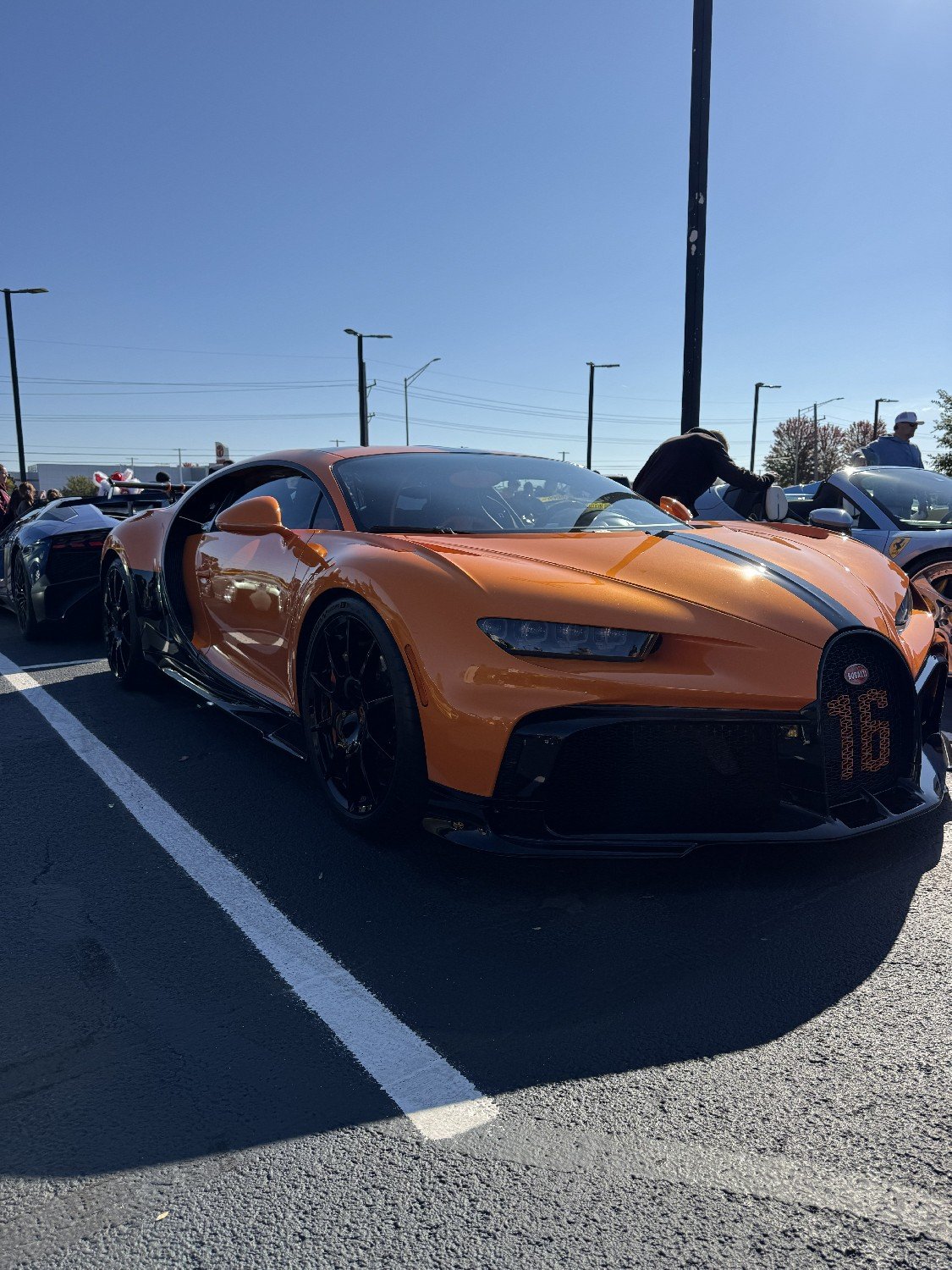 An orange Bugatti supercar at Cars & Candy