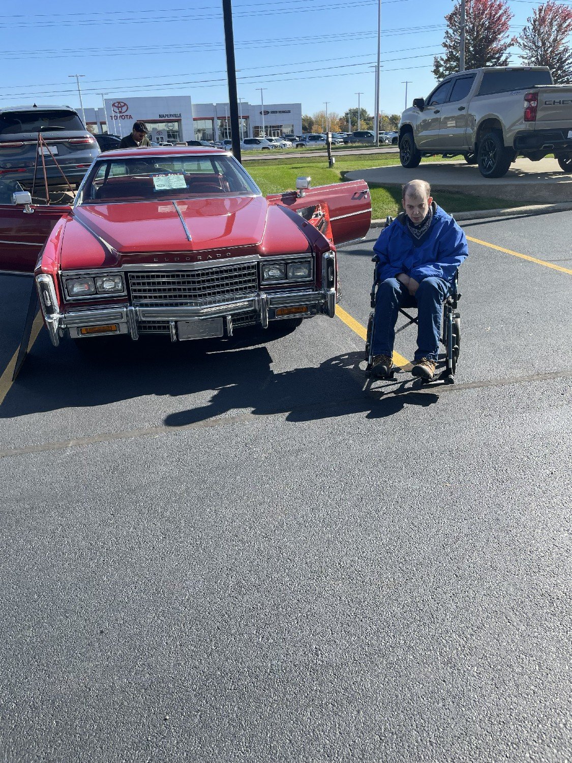 A classic red Cadillac Eldorado with a Be Yourself Group friend