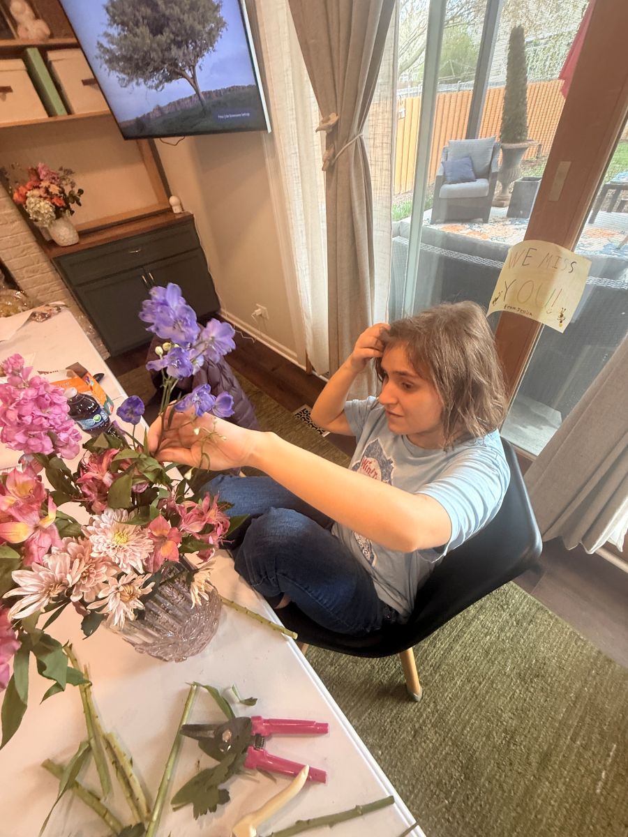 A team member arranging flowers at the studio table